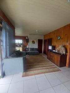 ein Wohnzimmer mit einem Sofa und einem Tisch in der Unterkunft Casa de Veraneio em São Francisco do Sul - Praia do Ervino in São Francisco do Sul