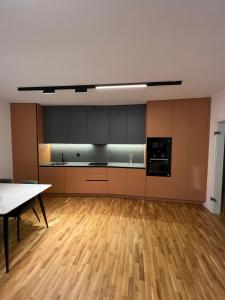 an empty room with a kitchen and a table at Four Seasons Apartment in Pristina