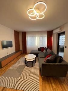a living room with a couch and a table at Four Seasons Apartment in Pristina