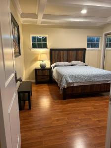1 dormitorio con 1 cama y suelo de madera en Private room near Facebook, Amazon, Stanford en East Palo Alto