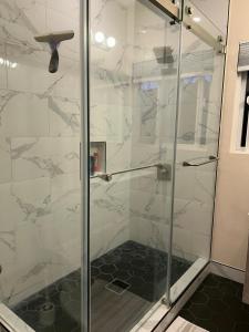 a shower with a glass door in a bathroom at Private room near Facebook, Amazon, Stanford in East Palo Alto