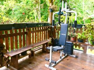 a bench sitting on a deck with a exercise bike at Pousada Boutique Rancho Campanário in Rancho Queimado