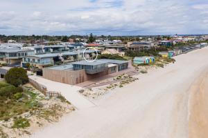 an aerial view of a beach with houses at Groves Sunset Views in Aspendale in Aspendale