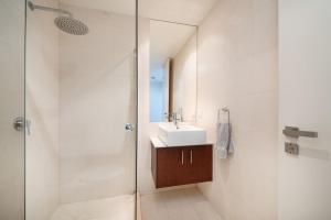 a bathroom with a sink and a shower at Groves Sunset Views in Aspendale in Aspendale