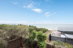 a view of the beach from the balcony of a house at Groves Sunset Views in Aspendale in Aspendale