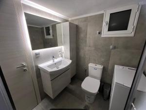 a small bathroom with a sink and a toilet at Serres city center modern apartment (Monika) in Serres