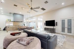 a living room with a couch and a tv at Starry Waters Retreat in Sarasota