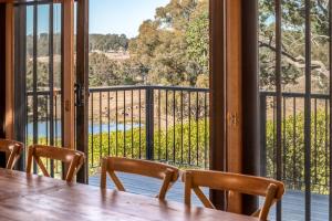 a dining room with a table and a view of a balcony at Bonvilla Estate in Pokolbin