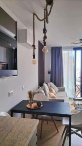 a living room with a couch and a table at Luxury Penthouse Valentin with jacuzzi in Corralejo
