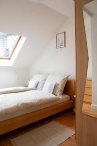 a bedroom with a bed with white sheets and a window at Balcony Dohany Street Apartment in Budapest