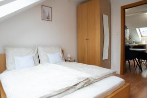 a bedroom with a large bed with white sheets at Balcony Dohany Street Apartment in Budapest