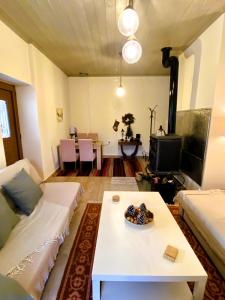 a living room with a couch and a table at Methydrion Country House in Vitina