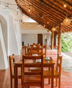 a dining room with wooden tables and chairs at Kaab Coba in Cobá