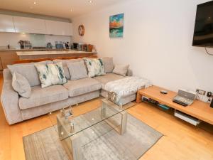 a living room with a couch and a coffee table at 9 Headland Point in Newquay