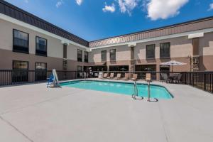 a swimming pool in front of a building at Best Western Albemarle Inn in Albemarle