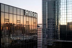 a building with a reflection of a city at Hilton Tampa Downtown in Tampa