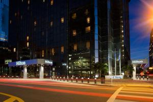 a building at night with a street in front of it at Hilton Tampa Downtown in Tampa