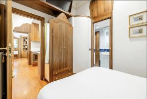 a bedroom with a white bed and wooden cabinets at Pantheon Antique Suite in Rome