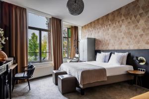 a hotel room with a bed and a window at Boutique Hotel View in Amsterdam