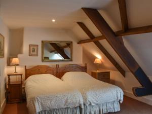 a bedroom with a bed and a mirror at Chetnole Mill in Chetnole