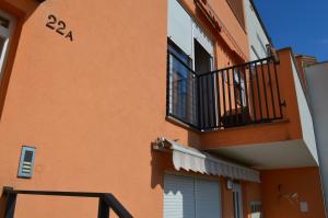 an orange building with a balcony and a door at Apartment Meli in Sesvete