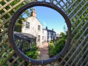 a mirror in a fence looking at a street at The Moat House in Annan