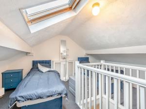 a attic bedroom with a bed and a skylight at The Shrubbery in Worcester