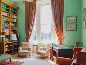 a living room with a desk and chairs and a window at Dalnaglar Castle - Uk7072 in Cray