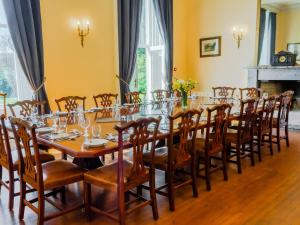 a long dining room with a long table and chairs at Dalnaglar Castle - Uk7072 in Cray