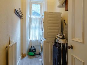 a room with a door and a suitcase next to a window at The Old Nunnery - Uk7122 in Skelmorlie