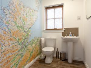 a bathroom with a toilet and a map on the wall at Number 2 - Uk7451 in Dornoch