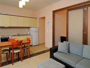 a kitchen and a living room with a couch and a table at Karayiannis Villas in Nafplio