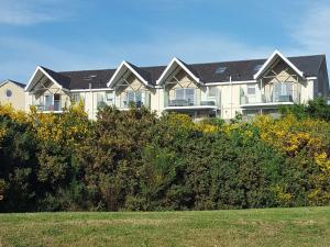 a large apartment building with a lot of windows at Fairway Apartment in Nairn