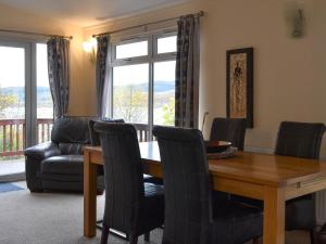 a dining room with a table and chairs at Island View Lodge in Tarbert