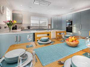 a kitchen with a table with a bowl of fruit on it at Terra Verde in Beauly