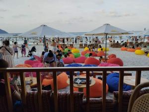 a group of people laying on the beach at White's house in Quan Lạn