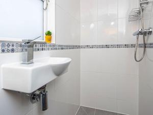 a white bathroom with a sink and a shower at The Drift Shepherds Hut - Ukc6878 in Aultgrishin