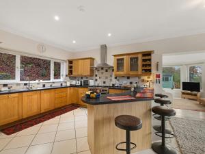 a large kitchen with wooden cabinets and a counter at Taigh Geal in Foyers