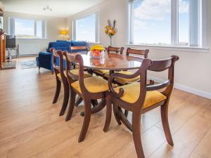 a dining room with a wooden table and chairs at Sunny Hill - Ukc6884 in Aultgrishin