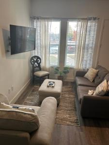 a living room with a couch and a flat screen tv at Atlanta Cozy Loft Apartment in Atlanta