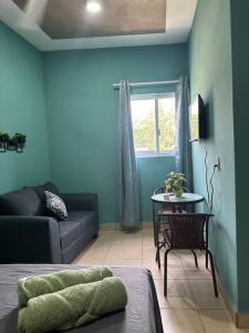 a living room with a couch and a table at Brisa del mar #7 in Puerto Escondido +8 photos