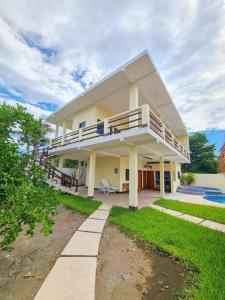 Cette grande maison dispose d'un balcon et d'une piscine. dans l'établissement El descanso monterrico, à Santa Rosa