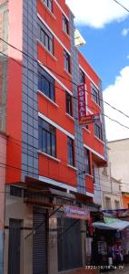 a red building with a sign in front of it at HOSTAL ETERNA PRIMAVERA in Copacabana