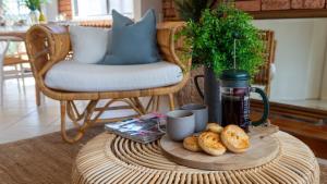 a table with a tray of bread and cups on it at Sunrise Sands in Callala Beach