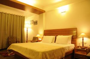 Postel nebo postele na pokoji v ubytování Vatsalyam Home Stay
