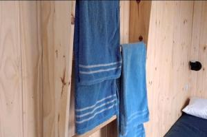 a room with a blue towel hanging on a wall at Quarto Privado em Santana de Parnaíba in Santana de Parnaíba