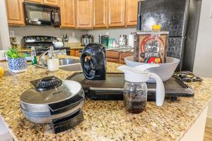 a kitchen counter with a mixer and a sink at Steam in the year round hot tub after a Ski trip in South Jordan