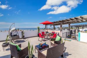a patio with a table and chairs and the ocean at Bright Chick Condo 19 Gardenhaus in Tijuana