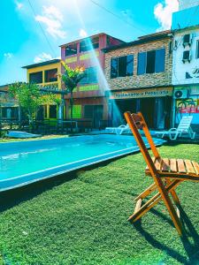 a beach chair sitting next to a swimming pool at Pousada França in Japaratinga