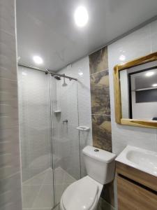 a bathroom with a shower and a toilet and a sink at Apartahotel Sevilla in Medellín